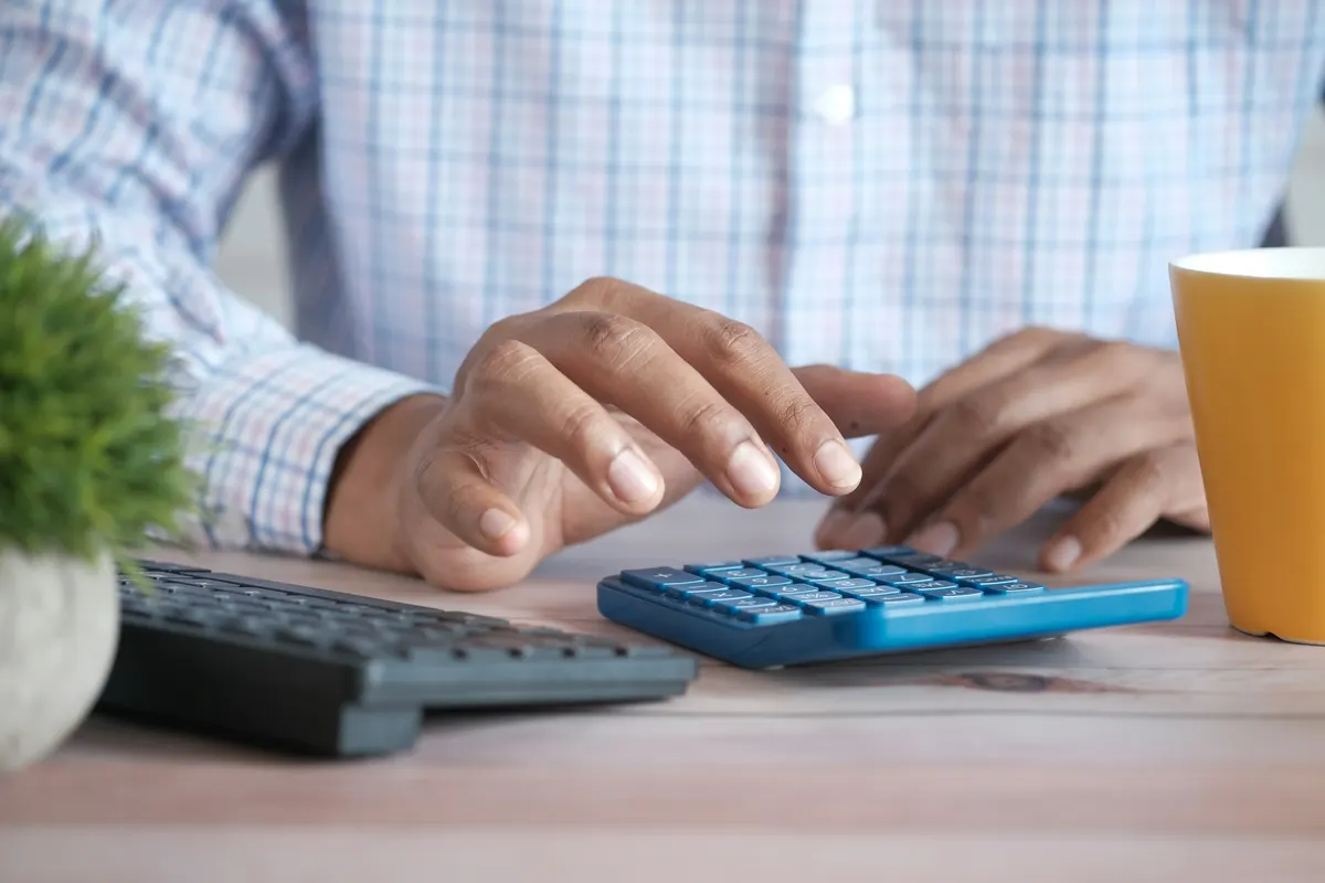 Retirement planning with documents and a calculator on a desk